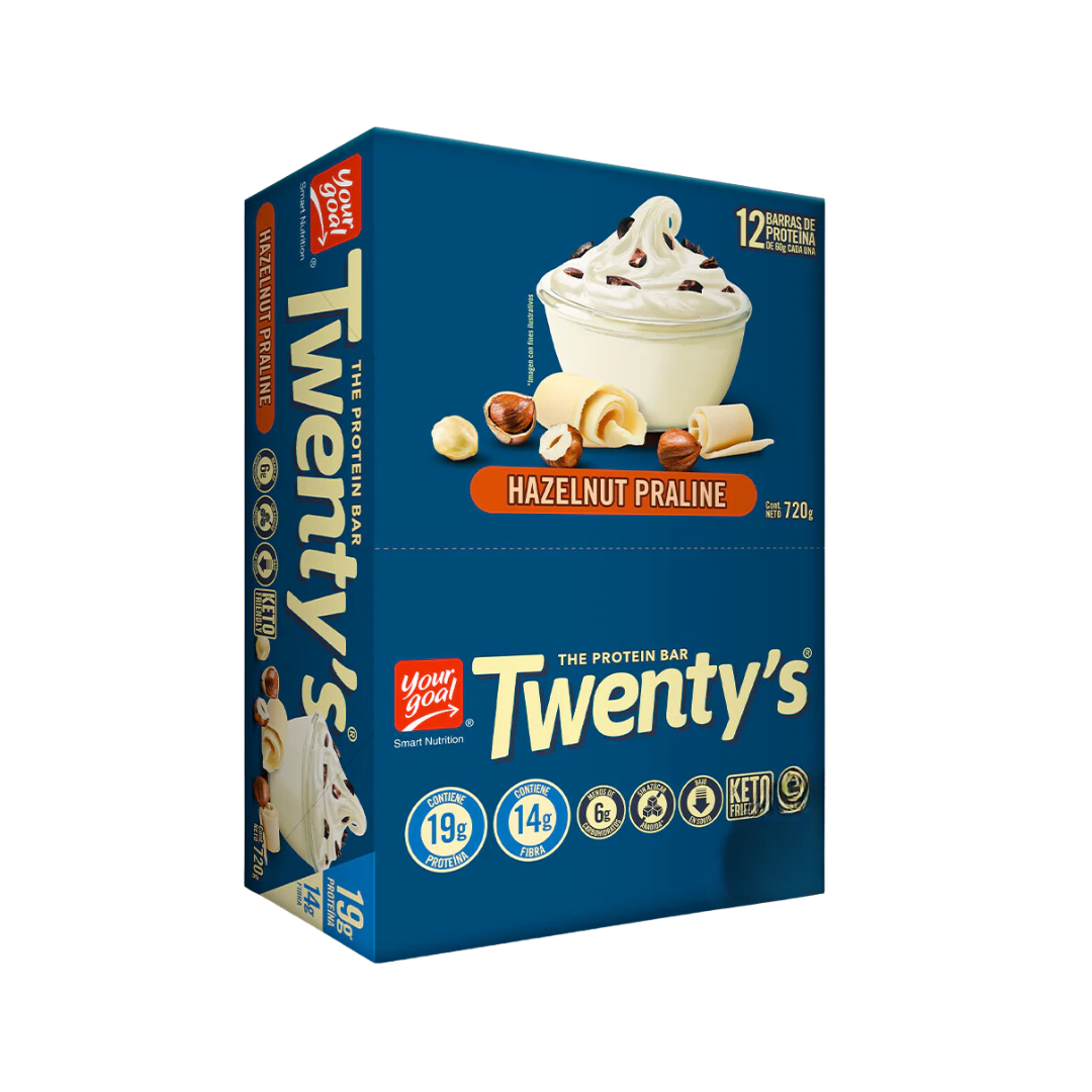 Una caja azul de Praliné de Avellanas Barras De Proteina Twenty 12un de YOUR GOAL, con la imagen de un postre con frosting blanco y avellanas. El empaque destaca la información nutricional: 19 g de proteína, 14 g de fibra, 6 g de carbohidratos netos, apto para ceto. Contiene 12 barras, 720 g en total, perfectas para tus objetivos de acondicionamiento físico.